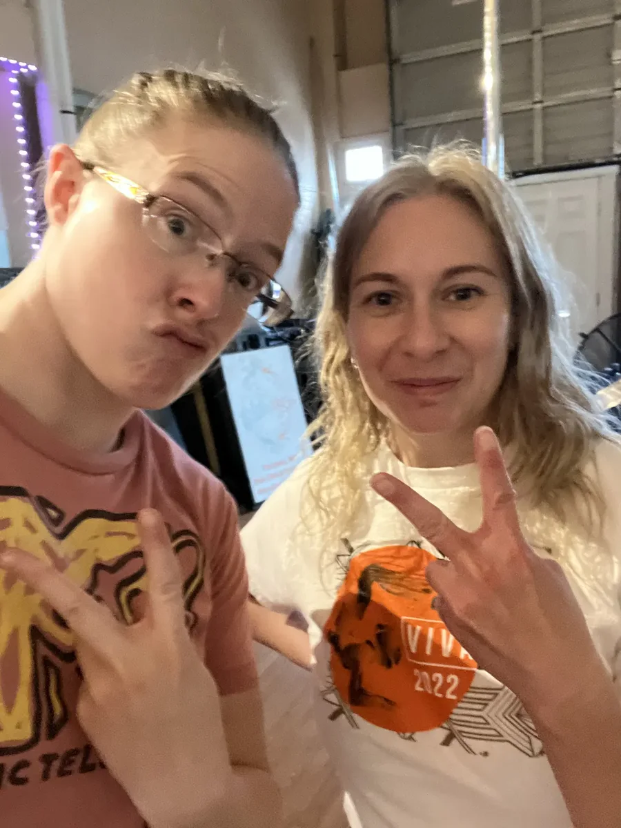 Two Starbound members posing together with peace signs at the studio