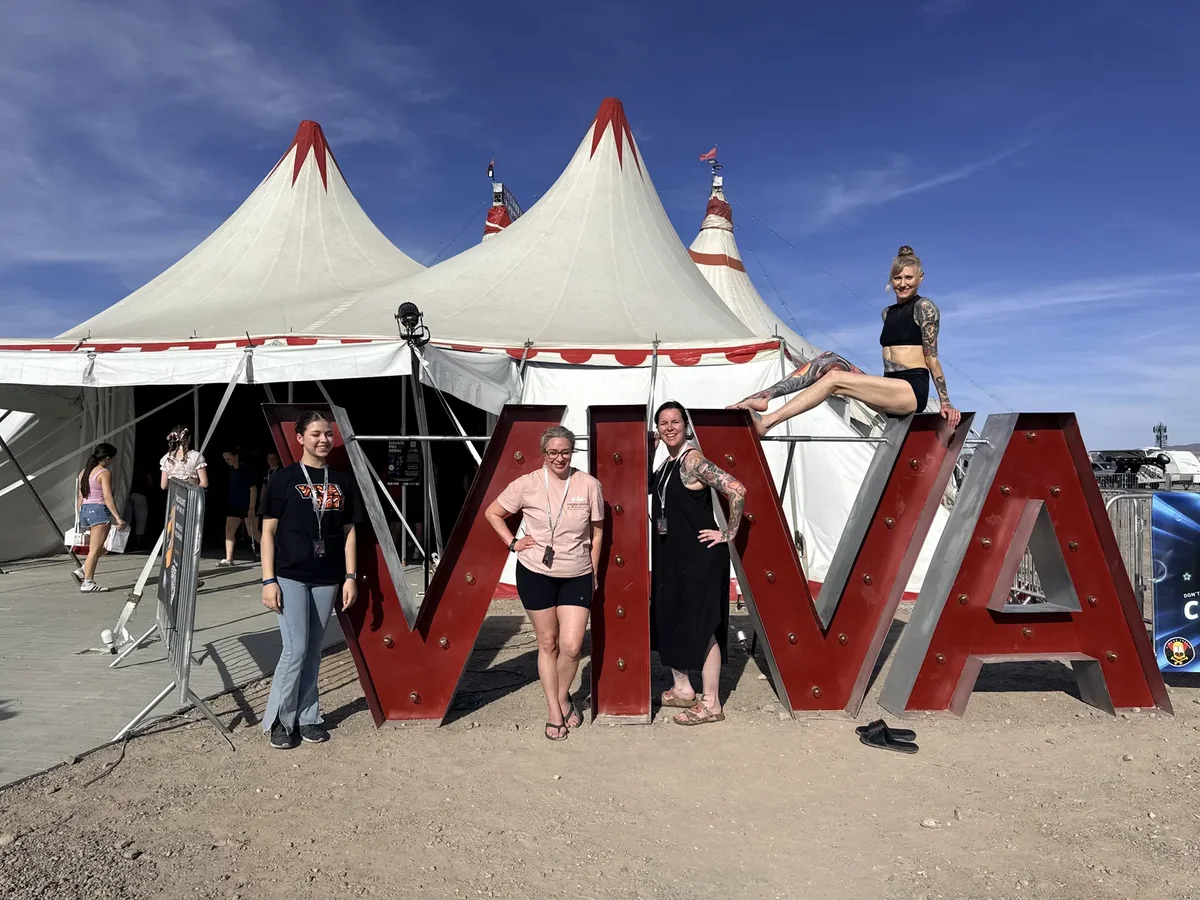 Starbound members posing in front of circus tents and a large marquee sign