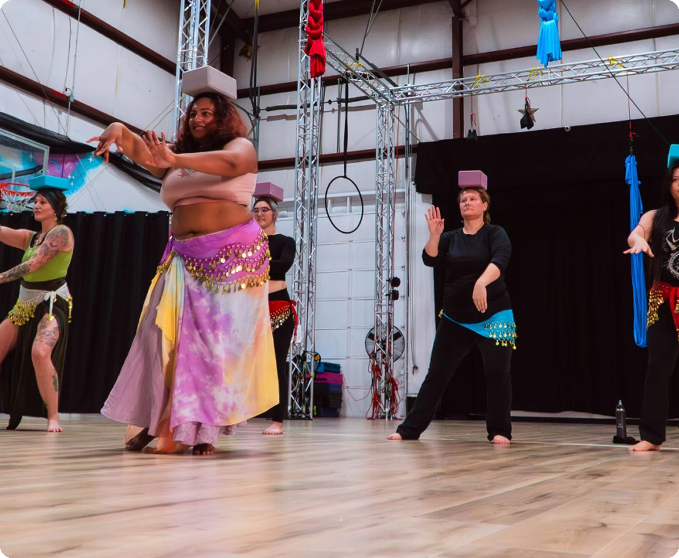 Students following along in a belly dance class at the studio
